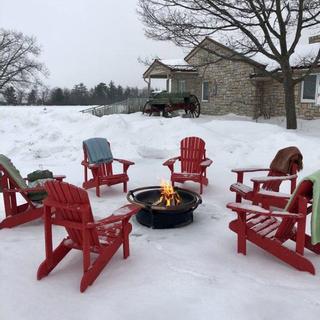 Christie's Mill Inn and Spa | Port Severn, Ontario | Red Muskoka chairs around outside fire