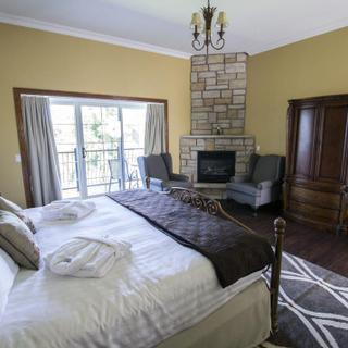 Christie's Mill Inn and Spa | Port Severn, Ontario | King bedroom with fireplace and robes on bed