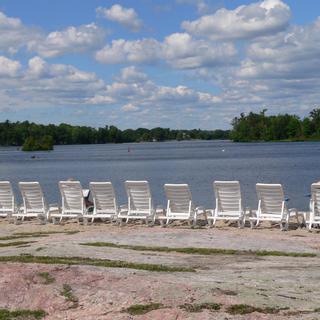 Christie's Mill Inn and Spa | Port Severn, Ontario | White beach chairs laid out by lake