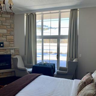 Christie's Mill Inn and Spa | Port Severn, Ontario | Queen bed with fireplace and table and chairs