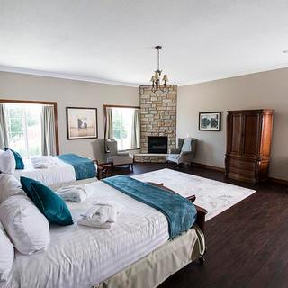Christie's Mill Inn and Spa | Port Severn, Ontario | Two queen beds with desk area, fireplace and brown armoire