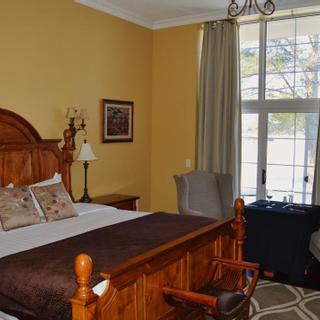 Christie's Mill Inn and Spa | Port Severn, Ontario | King bed and table with two lounge chairs