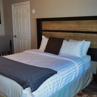 Christie's Mill Inn and Spa | Port Severn, Ontario | Queen bed with side table and work desk