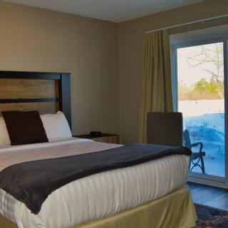 Christie's Mill Inn and Spa | Port Severn, Ontario | Queen bedroom with sliding doors to outdoor patio