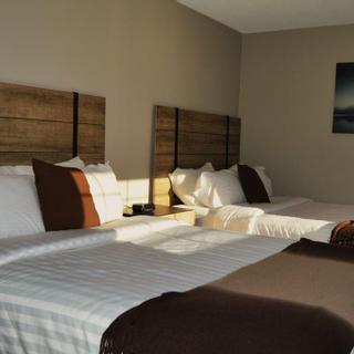 Christie's Mill Inn and Spa | Port Severn, Ontario | Sunlight illuminating two double beds